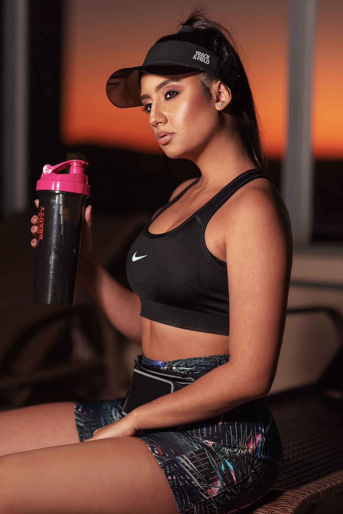 Athlete holding a black protein shaker bottle