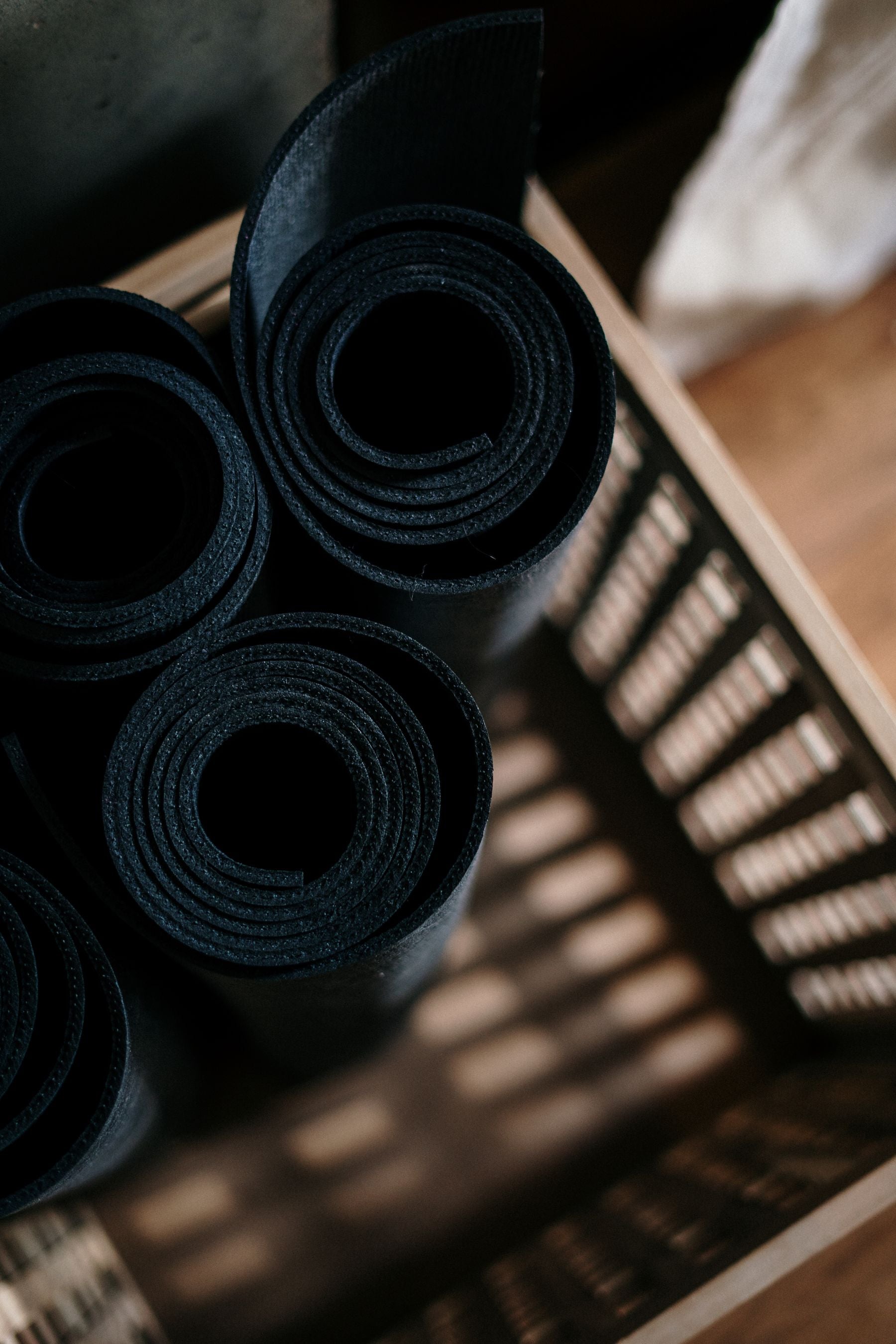 Close-up of rolled exercise mats in a basket